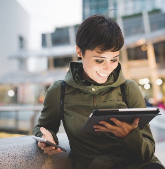 Woman smiling while using a tablet