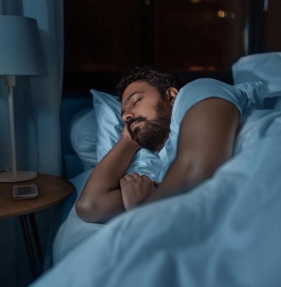 Man sleeping peacefully on his side after myofunctional therapy exercises in Northern Arizona