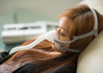 Sleeping woman with a C P A P mask over her face