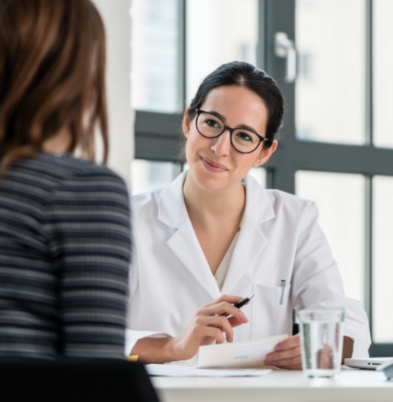 Doctor sitting across table from a patient