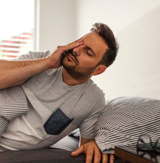 a man waking up groggy in the morning