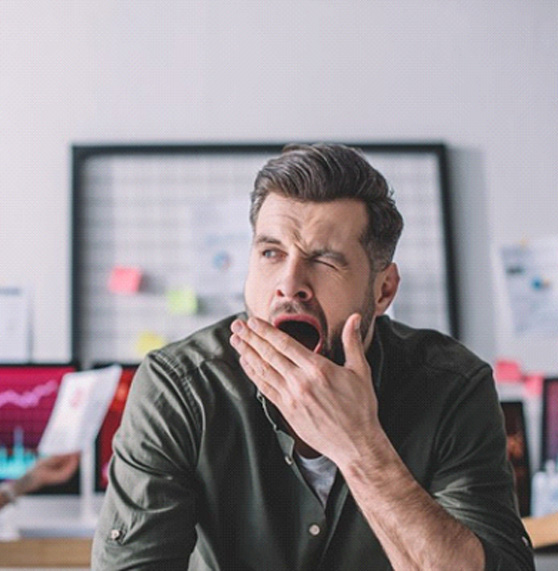 a man yawning while at the office