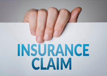 Hand holding insurance claim form