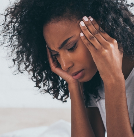 Woman rubbing her temples in frustration